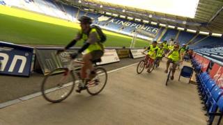 Cyclists inside the King Power Stadium