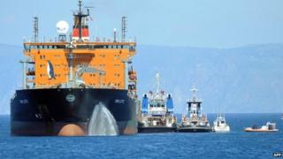 The transfer of immigrants from the tanker "Torm Lotte" to tug boat "Grifone" in the middle of Messina's marine channel following a rescue operation on 20 July 2014.