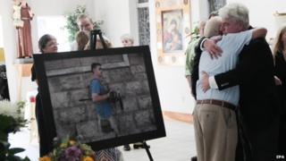 John Foley (R), father of James Foley, hugs a man during a memorial service for slain US journalist James Foley in Rochester, New Hampshire