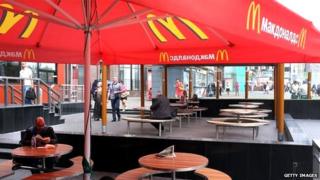 Tables outside Moscow McDonalds, mostly standing empty