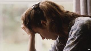 Picture of woman with head in hands