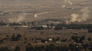 Smoke rises from the Syrian Golan Heights during clashes between Syrian rebels and government forces on 28 August 2014