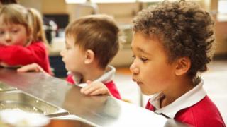 Infant children queue for lunch generic