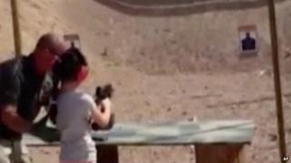 A still from the video of a 9-year-old girl shortly before she accidentally shot a man with an Uzi.
