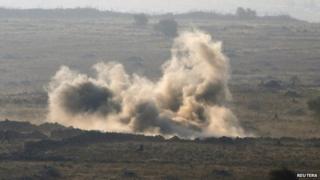 Syrian army soldiers are seen during a battle with rebel fighters in Syria near the border fence with the Israeli-occupied Golan Heights