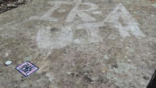 Graffiti was sprayed on headstones in the early hours of Wednesday morning