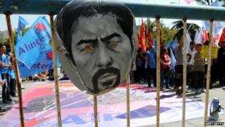 A mask depicting the face of Ethem Sarisuluk hangs on a police barrier outside the courthouse in Ankara on 3 September 2014