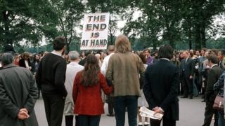 A man with a sign saying THE END IS AT HAND talks to the crowd at Speakers' Corner, Hyde Park, London on 11 June 1972.