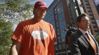 Glenn Adam Chin, left, a former supervisory pharmacist at the New England Compounding Center, walks with his attorney Paul Shaw, right, after appearing in federal court, 4 September 2014