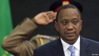 Kenya's President Uhuru Kenyatta stands for Kenya's national anthem before the Africa Union Peace and Security Council Summit on Terrorism at the Kenyatta International Convention Centre in Nairobi, September 2, 2014
