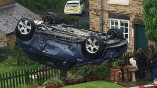 A car is lifted from a garden after a crash in Nether Haugh in May