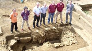 Archaeologist Jim Brown (left) and Alaric Neville (second left) with local brewery workers and the malting oven.