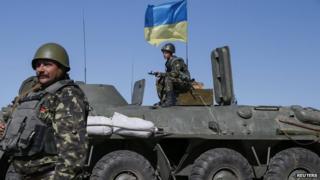 Ukrainian servicemen stand at a checkpoint near Debaltseve