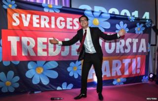 Jimmie Akesson celebrates in front of poster saying "Sweden's third largest party" (14 Sept)