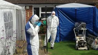 The garden of a house in Kings Close, Westcott, near Aylesbury, being searched by police