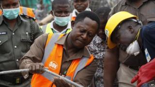 Officials inspecting the site of the building collapse, Lagos, Nigeria 16 September 2014