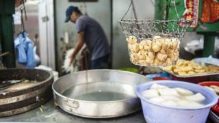 Street food in the Central district of Hong Kong on September 8, 2014. Pineapple buns and dumplings have been pulled from the shelves in Hong Kong