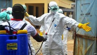 Guinean health workers wearing protective suits at a hospital in Conakry - 14 September 2014