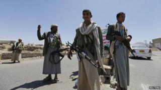 Shia Houthi rebels man a checkpoint they set up along a street in Sanaa on 21 September 2014.
