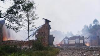 Ruins of a fireworks plant is seen on fire after an explosion in Liling, Hunan province on 22 September, 2014