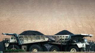 Coal trucks pass each other at BHP Billiton's Mt Arthur coal mine