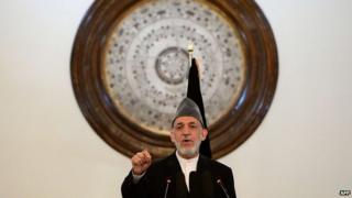 Outgoing Afghan President Hamid Karzai gestures as he addresses a gathering of government employees at the Presidential Palace in Kabul on September 23, 2014.