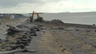 Rubble being cleared off the beach