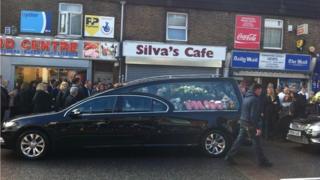 Funeral cortege outside Silva's Cafe