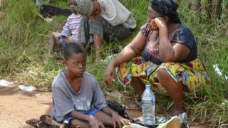 A resident sick from the Ebola virus waits on 23 September 2014 outside Island Clinic, a new Ebola treatment centre that opened in Monrovia, Liberia