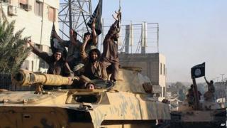 Members of Islamic State group parade in Raqqa, Syria