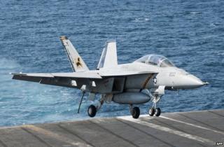 An F/A-18F Super Hornet lands aboard the aircraft carrier USS George HW Bush in the Gulf, 23 September