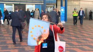 Woman burning flag at Conservative party conference