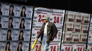 Man walks past election posters in Plovdiv