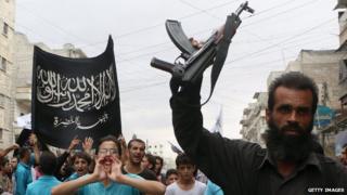 Supporters of the al-Nusra Front take part in a protest in Aleppo, Syria, against President Bashar al-Assad and the international coalition against Islamic State and other Islamist groups, on 24 September.