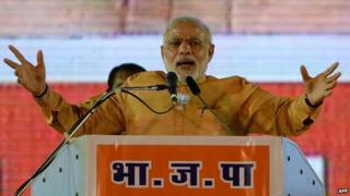 Indian Prime Minister and Bharatiya Janata Party leader Narendra Modi gestures as he speaks during a public rally ahead of the Maharashtra state election, in Mumbai on October 4, 2014