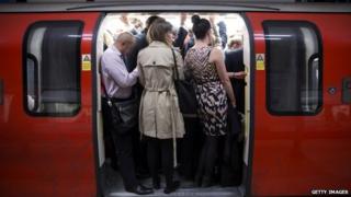 Commuters pack on to a Tube