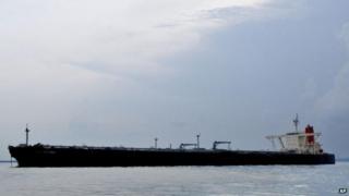 A crude oil tanker waits in Singapore Harbour on 27 May 2004