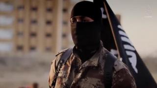 Masked Islamic State militant near 17th Division base in Raqqa province, Syria