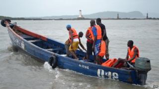 File photo: Rescue workers leave the coast to find the victims of a capsized boat in Conakry, 1 September 2012