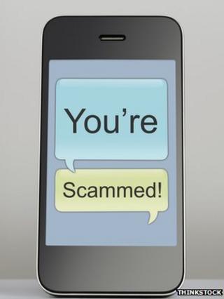 phone with "you're scammed" message