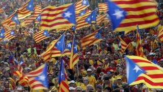People hold Catalan separatist flags during a protest in central Barcelona - 11 September 2014