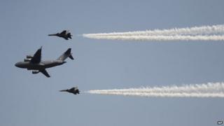 Indian Air Force"s C-17 Globemaster III, center, with Sukhoi Su-30MKI flies in formation whiles displaying aerial demonstration during Air Force Day at the air force station in Hindon near New Delhi, India, Wednesday, Oct. 8, 2014.