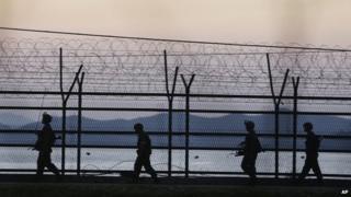 South Korean army soldiers patrol through the wire fences near the demilitarised zone between the two Koreas in Paju, South Korea, 7 October 2014