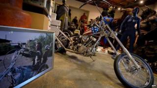 Easy Rider bike beside a still of Peter Fonda from the film