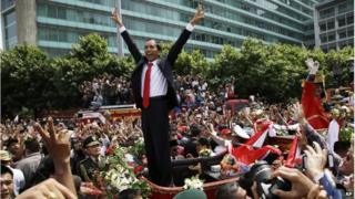 Indonesian President Joko Widodo gestures to the crowd during a street parade following his inauguration in Jakarta, Indonesia, 20 October 2014