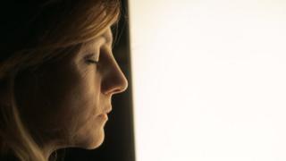 Woman standing by a light box