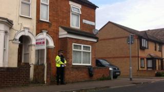 A police officer on guard outside a house