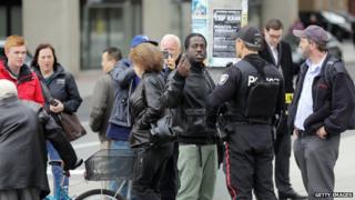 A police officer talks with a man near Parliament Hill in Ottawa on 22 October