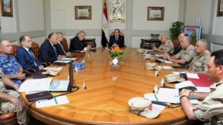 Egypt's President Abdul Fattah al-al-Sisi, centre, holds an emergency meeting of the National Defence Council with top officials after an attack in the Sinai Peninsula, in Cairo on 24 October 2014