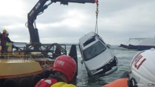 Car in the water at Sandbanks